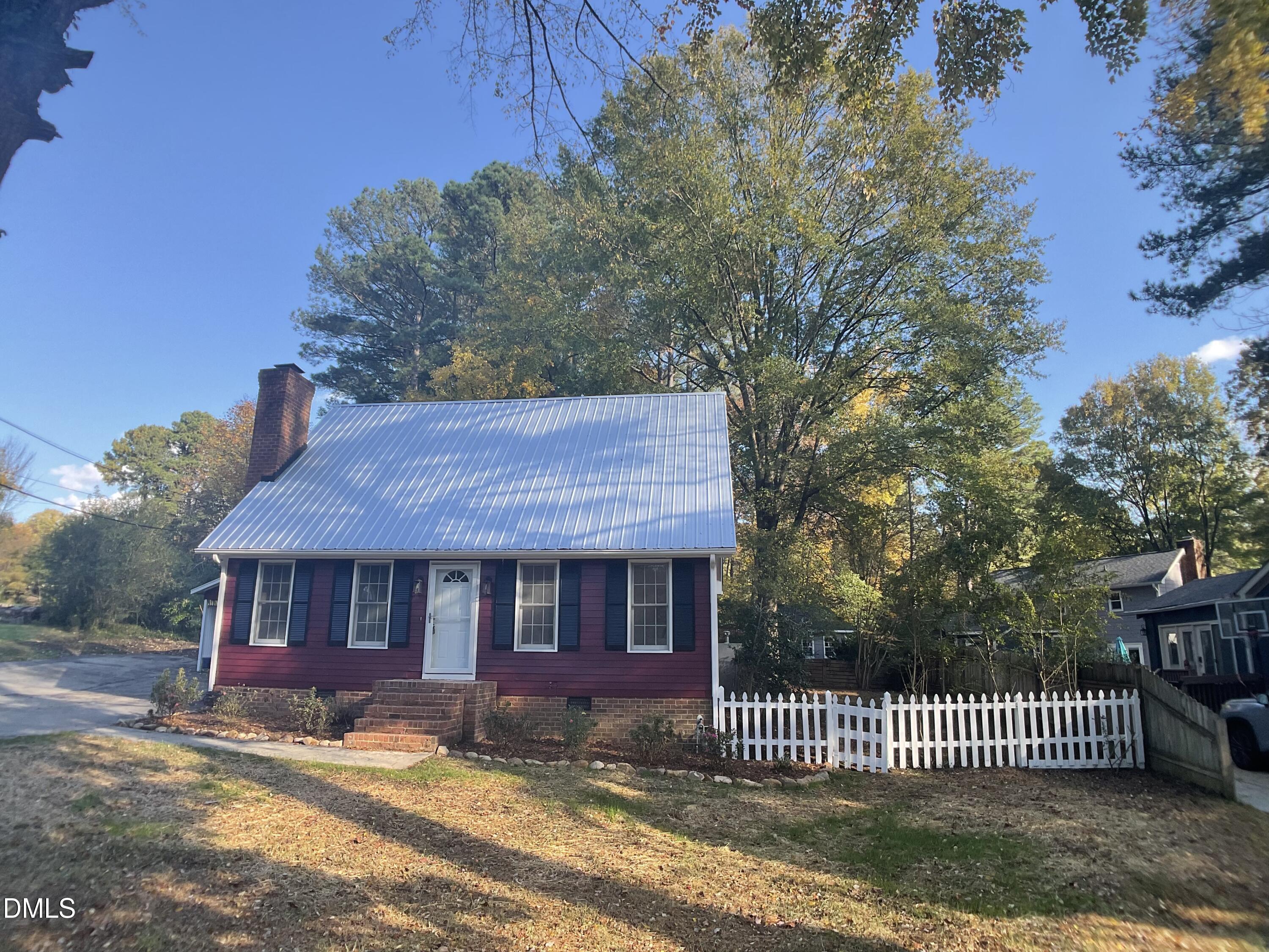 4219 Hope Valley Road Durham, NC 27707 - Photo 1 of 36 a front view of a house with a garden