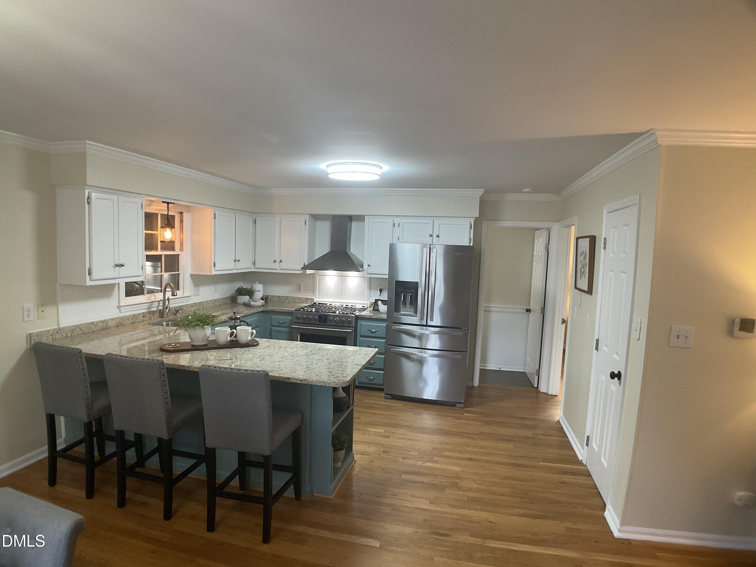 4219 Hope Valley Road Durham, NC 27707 - Photo 14 of 36 a kitchen with stainless steel appliances a dining table chairs refrigerator and sink