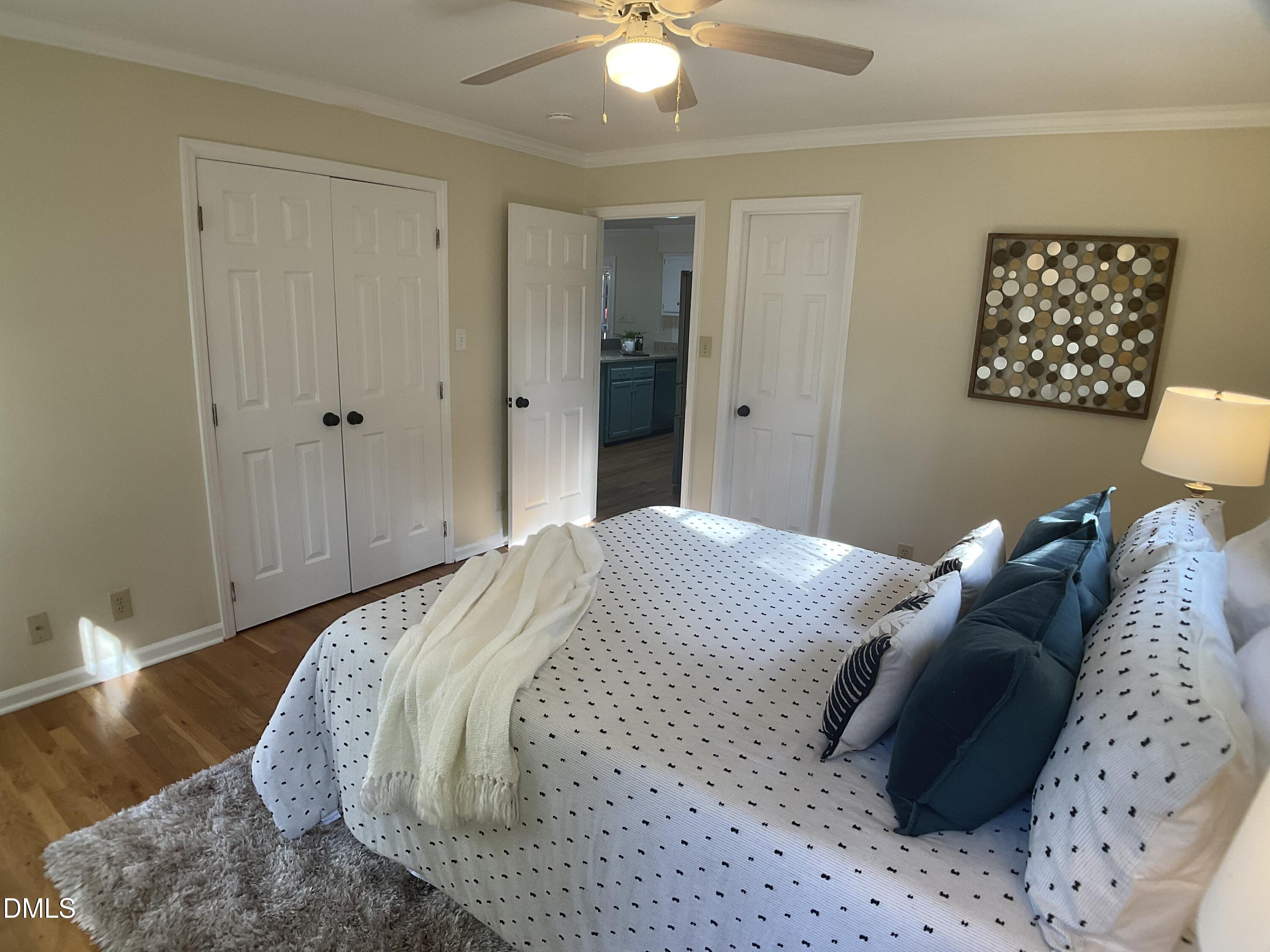 4219 Hope Valley Road Durham, NC 27707 - Photo 19 of 36 a bedroom with a bed and a painting on the wall