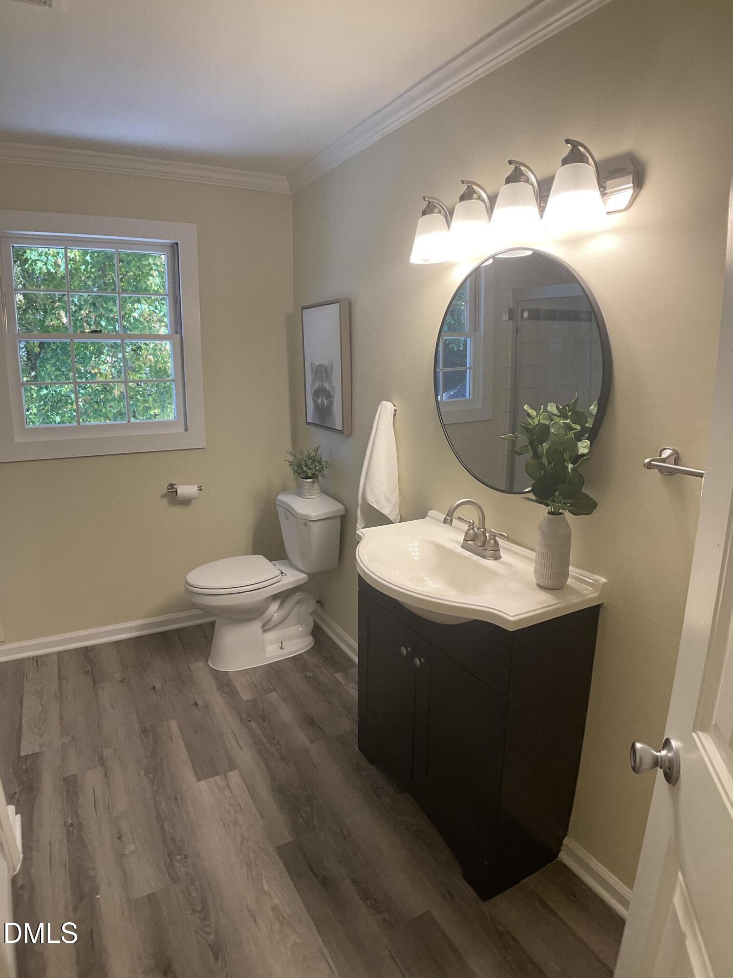 4219 Hope Valley Road Durham, NC 27707 - Photo 23 of 36 a room with a mirror and a wooden floor