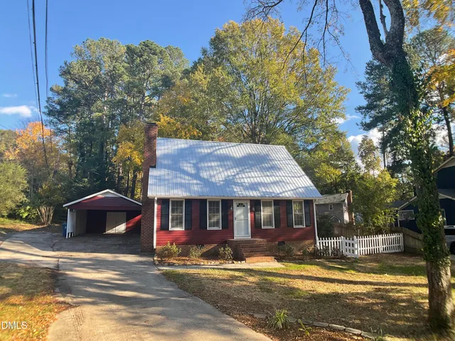 a view of a house with a yard next to a house