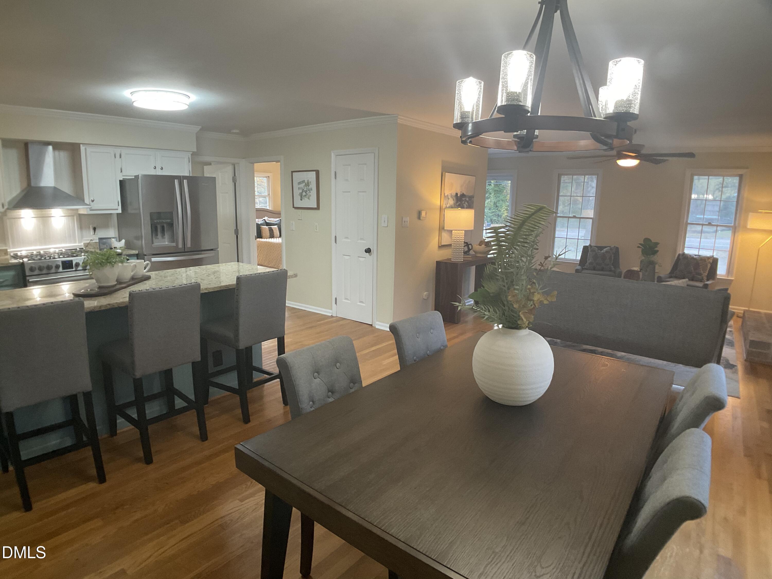 4219 Hope Valley Road Durham, NC 27707 - Photo 9 of 36 a view of a dining room with furniture and wooden floor