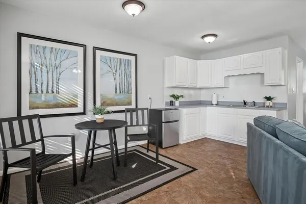 a kitchen with furniture and window