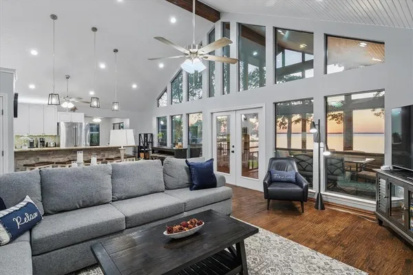 a living room with furniture ceiling fan and a rug