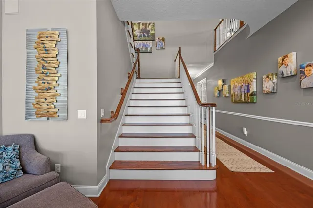 a view of a hallway with wooden floor and entryway