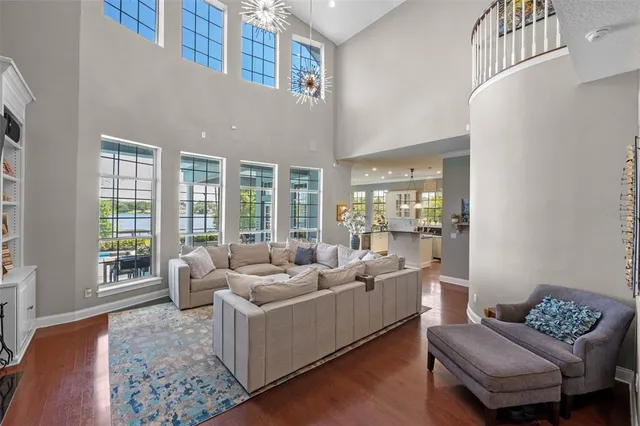 a bedroom with a large bed a chandelier and dresser