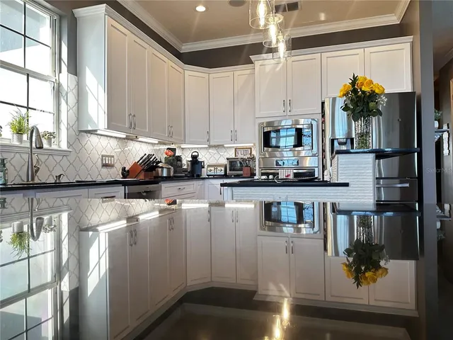 a view of a patio with wooden floor table and chairs