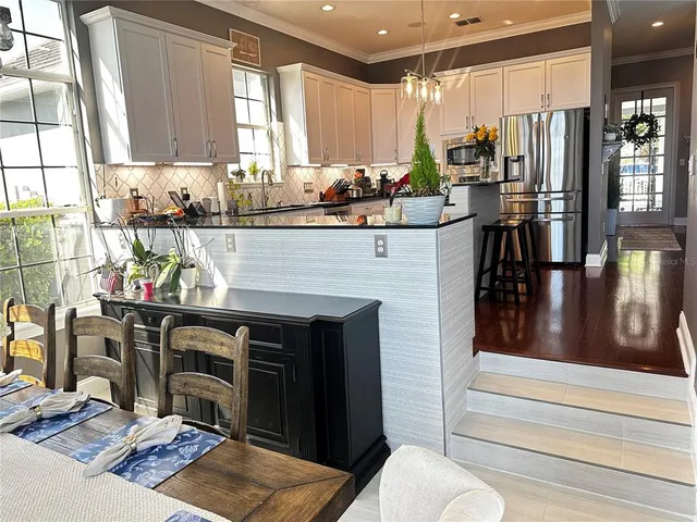 an aerial view of residential houses with outdoor space and trees