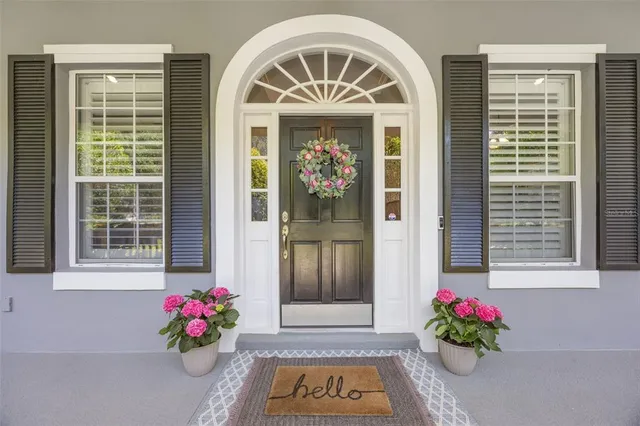a living room with furniture a fireplace and a chandelier