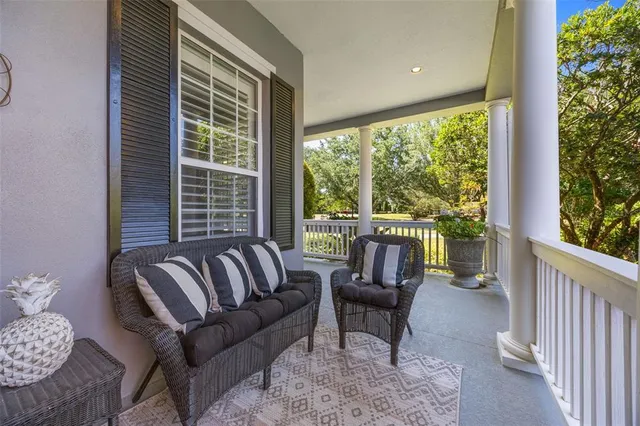 a living room with furniture a fireplace and a large window