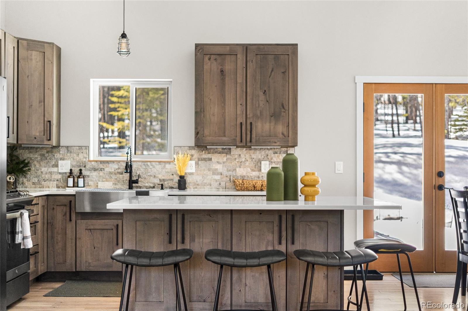 79 Beaver Road Idaho Springs, CO 80452 - Photo 15 of 50 a kitchen with stainless steel appliances a sink table and chairs in it