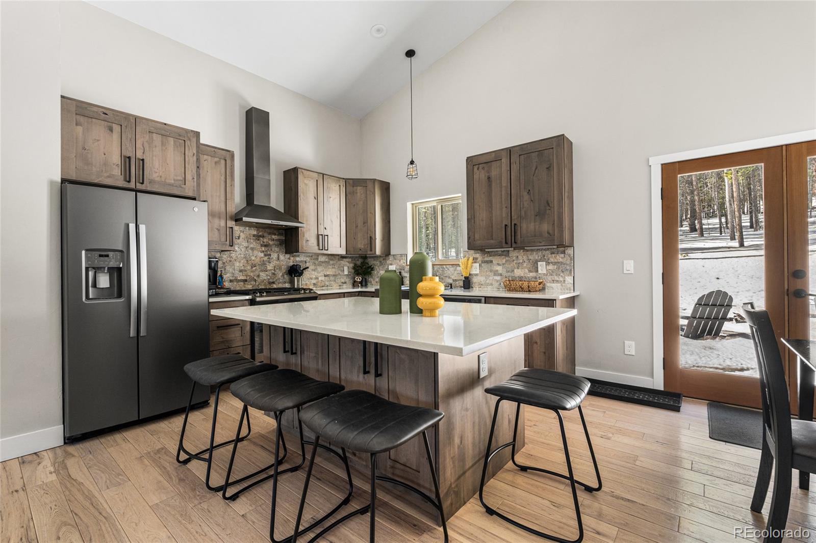 79 Beaver Road Idaho Springs, CO 80452 - Photo 18 of 50 a kitchen with stainless steel appliances a refrigerator and a stove top oven