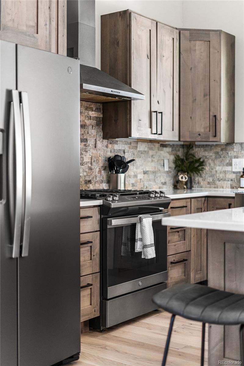 79 Beaver Road Idaho Springs, CO 80452 - Photo 19 of 50 a kitchen with stainless steel appliances a stove microwave and cabinets