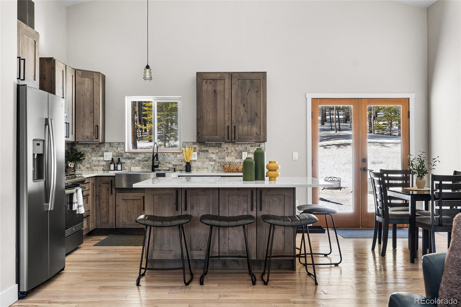 79 Beaver Road Idaho Springs, CO 80452 - Photo 20 of 50 a kitchen with stainless steel appliances a dining table chairs and granite counter tops