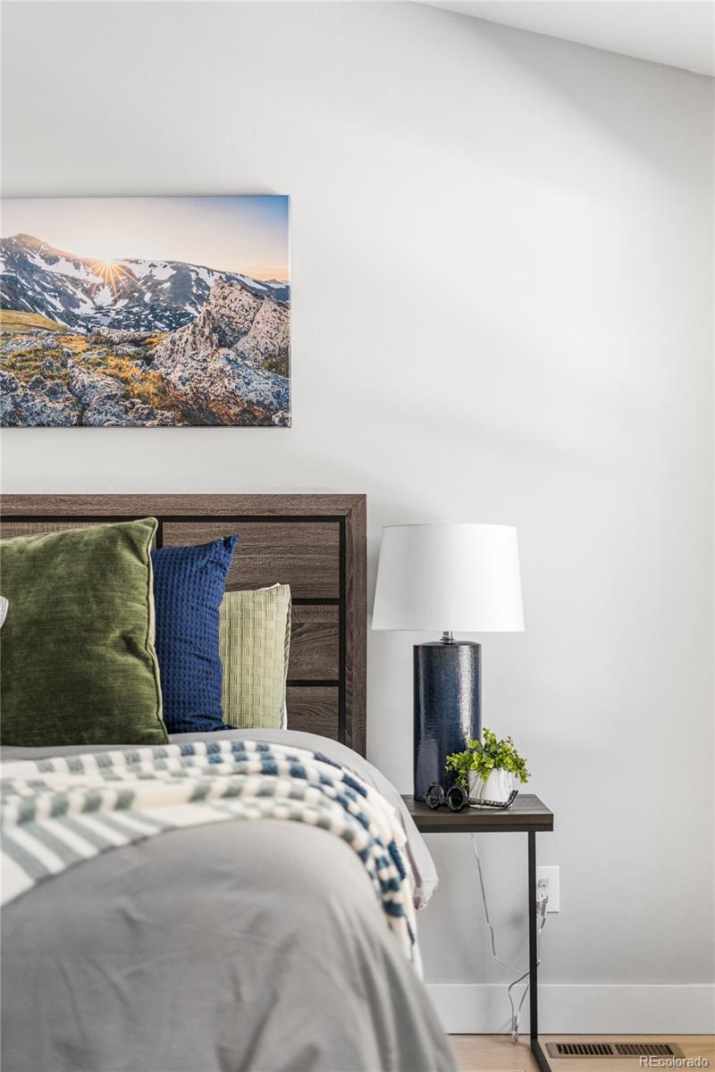 79 Beaver Road Idaho Springs, CO 80452 - Photo 26 of 50 a bedroom with a bed and a painting on the wall