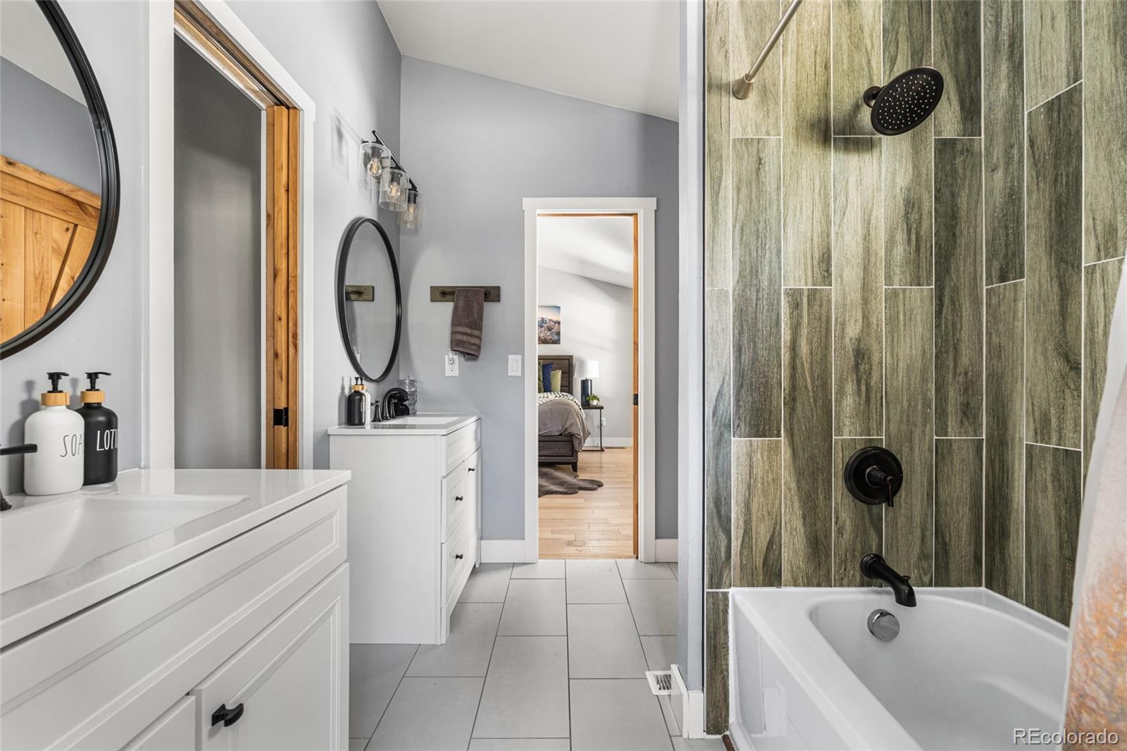 79 Beaver Road Idaho Springs, CO 80452 - Photo 29 of 50 a bathroom with a tub sink and mirror