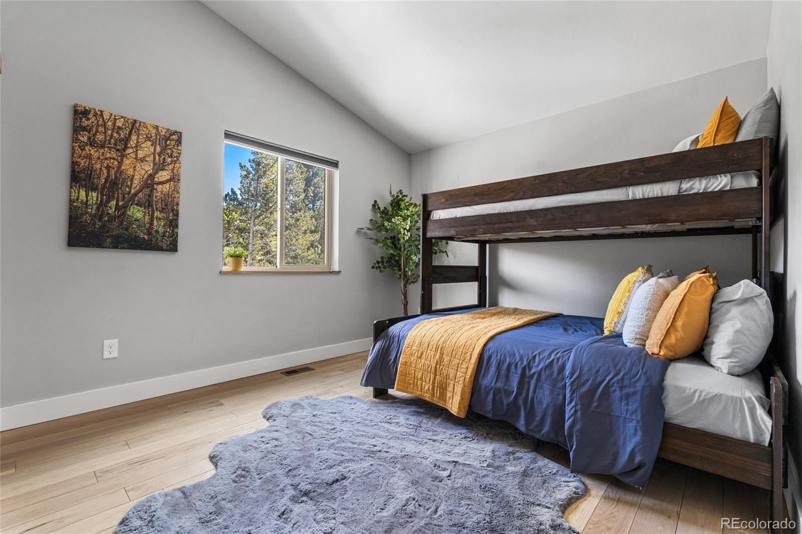 79 Beaver Road Idaho Springs, CO 80452 - Photo 36 of 50 a bedroom with two beds and a painting on the wall