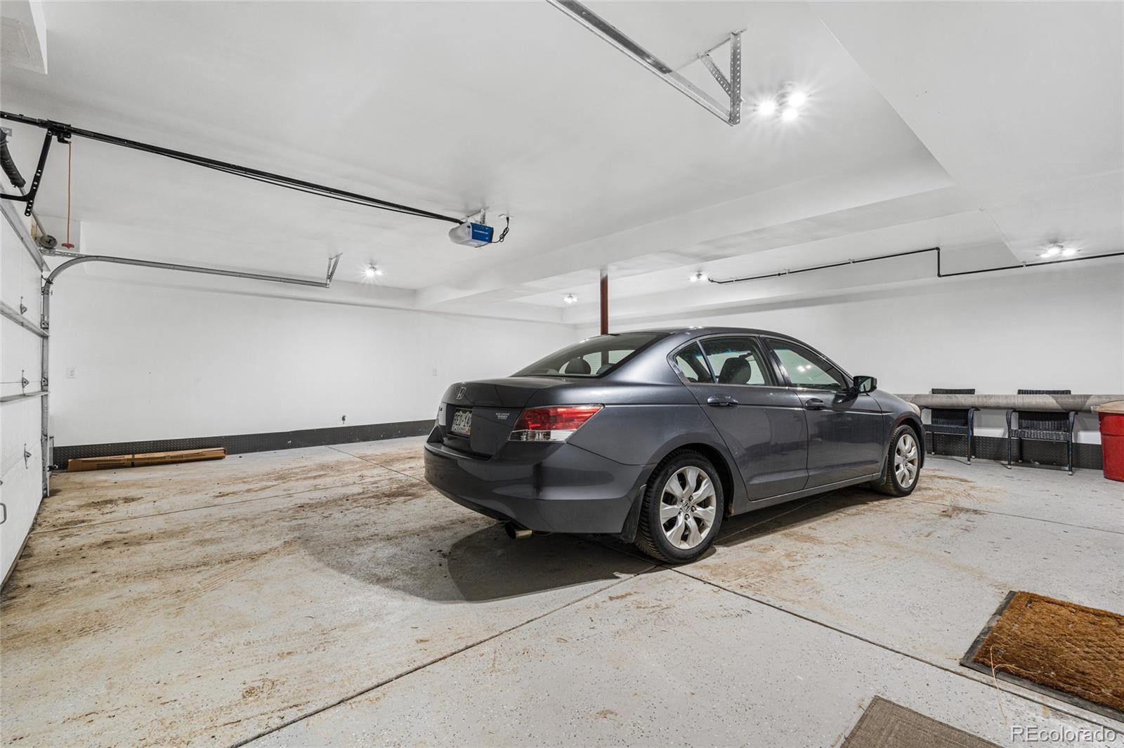 79 Beaver Road Idaho Springs, CO 80452 - Photo 40 of 50 a view of parking garage with cars and a ceiling fan