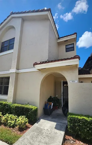 a view of entryway with a flower plants in front of main door
