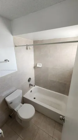 a view of backyard with outdoor seating and plants