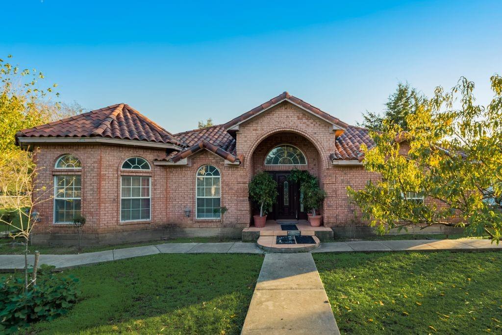 5310 Ranchero Lane Dallas, TX 75236 - Photo 1 of 1 View of front of property with a front lawn, brick siding, and a tiled roof
