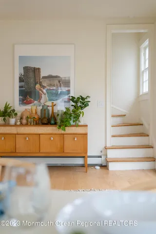 a living room with furniture a fireplace and a potted plant