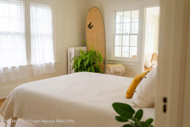 a bedroom with a bed and a potted plant