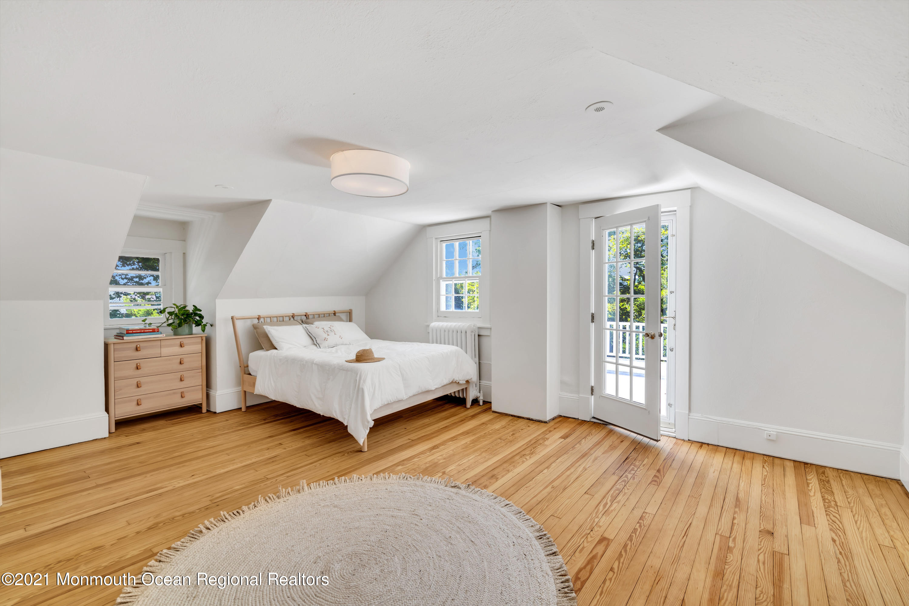 501 3rd Avenue Spring Lake, NJ 07762 - Photo 40 of 61 a spacious bedroom with a bed and a wooden floor