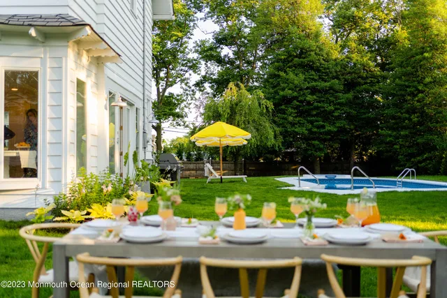a view of a swimming pool with a table and chairs
