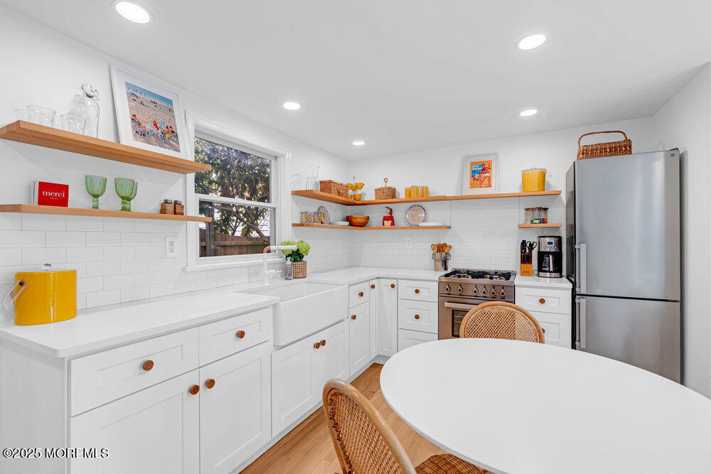 501 3rd Avenue Spring Lake, NJ 07762 - Photo 47 of 61 a kitchen with stainless steel appliances a refrigerator and a stove top oven