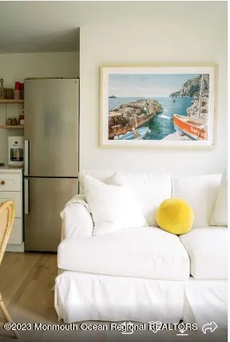 a front view of a house with garden and trees