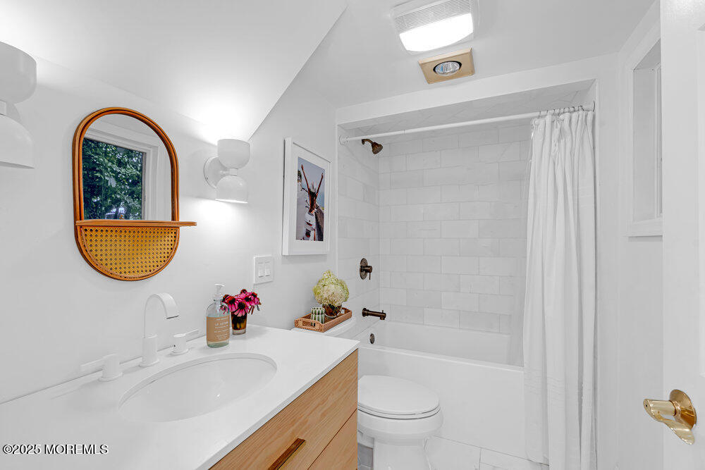501 3rd Avenue Spring Lake, NJ 07762 - Photo 50 of 61 a bathroom with a tub sink and mirror