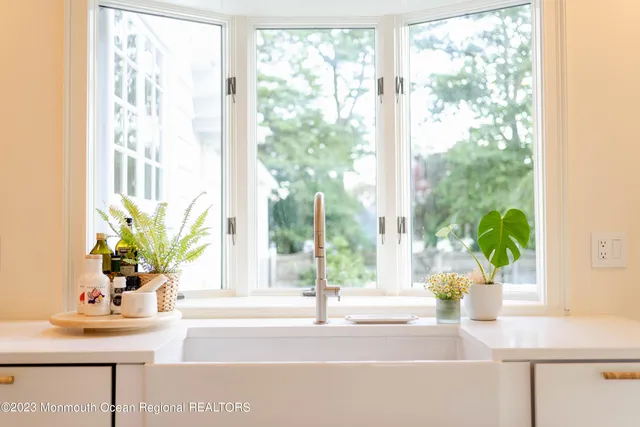 a view of a living room with a table and chairs