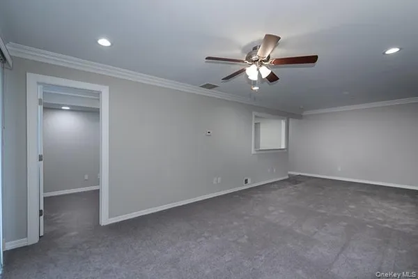 an empty room and chandelier fan