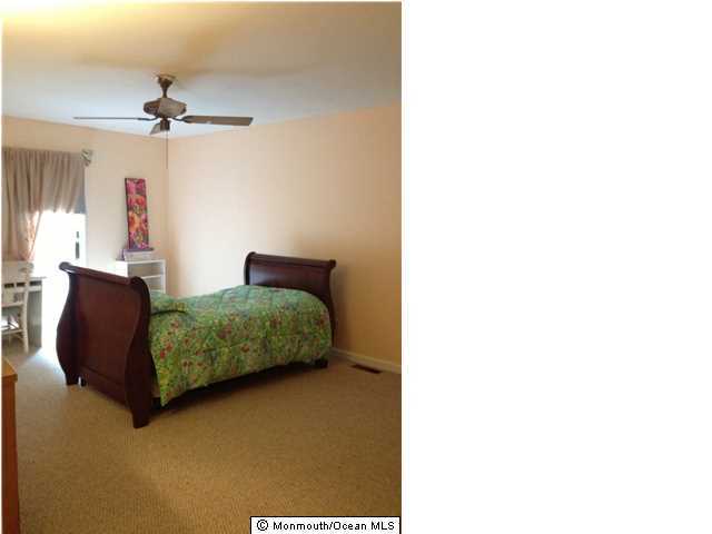 795 Hulses Corner Road Howell, NJ 07731 - Photo 14 of 22 a bedroom with a bed and a chandelier