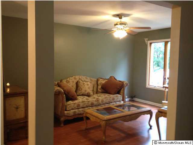 795 Hulses Corner Road Howell, NJ 07731 - Photo 7 of 22 a living room with furniture and a chandelier