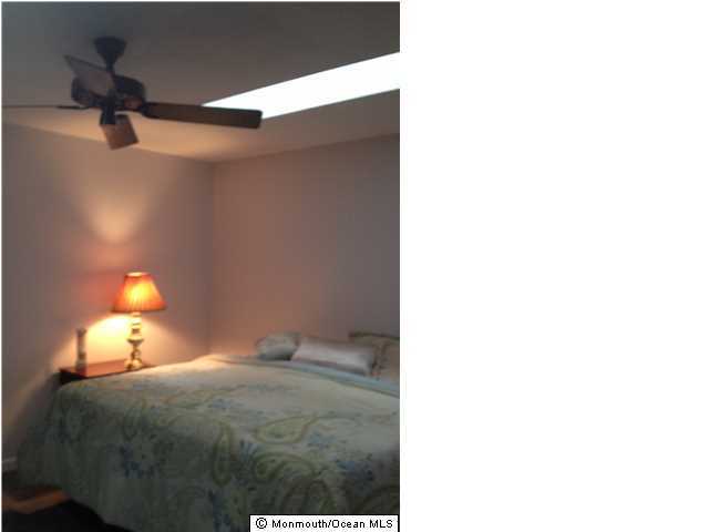 795 Hulses Corner Road Howell, NJ 07731 - Photo 10 of 22 a bedroom with a bed and a lamp