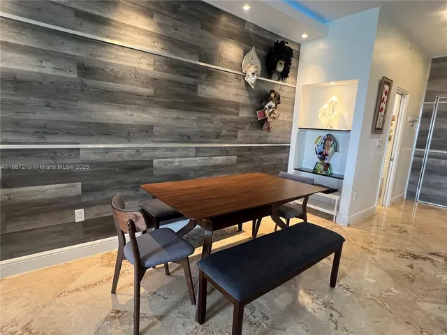 a view of a chairs and table in a backyard