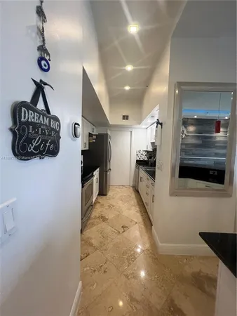 a view of a hallway to the kitchen