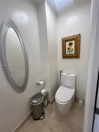 a bathroom with a toilet a sink and a mirror