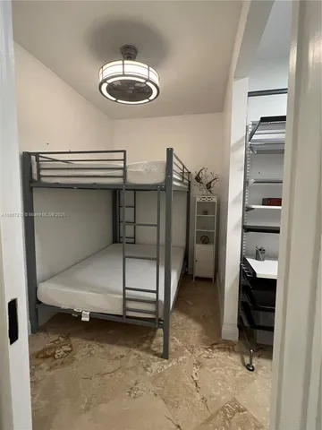 a kitchen with stainless steel appliances a refrigerator a sink a stove and white cabinets