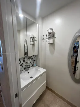 a bathroom with a toilet and a mirror