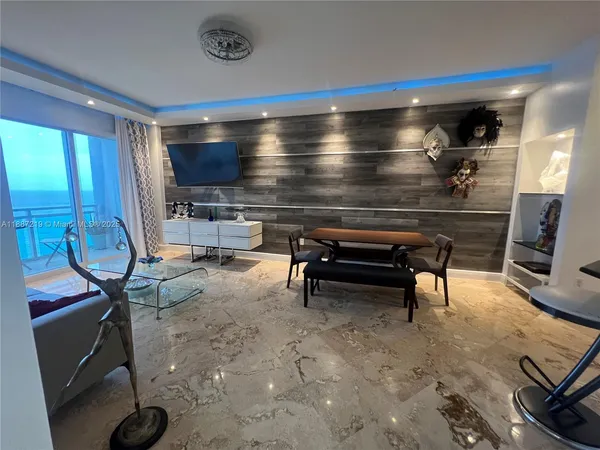 a living room with furniture a rug and a piano