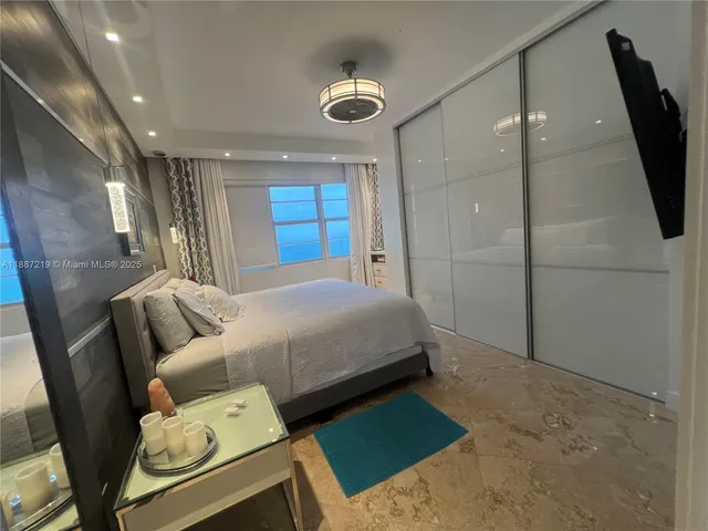 a bed room with a bed and a television