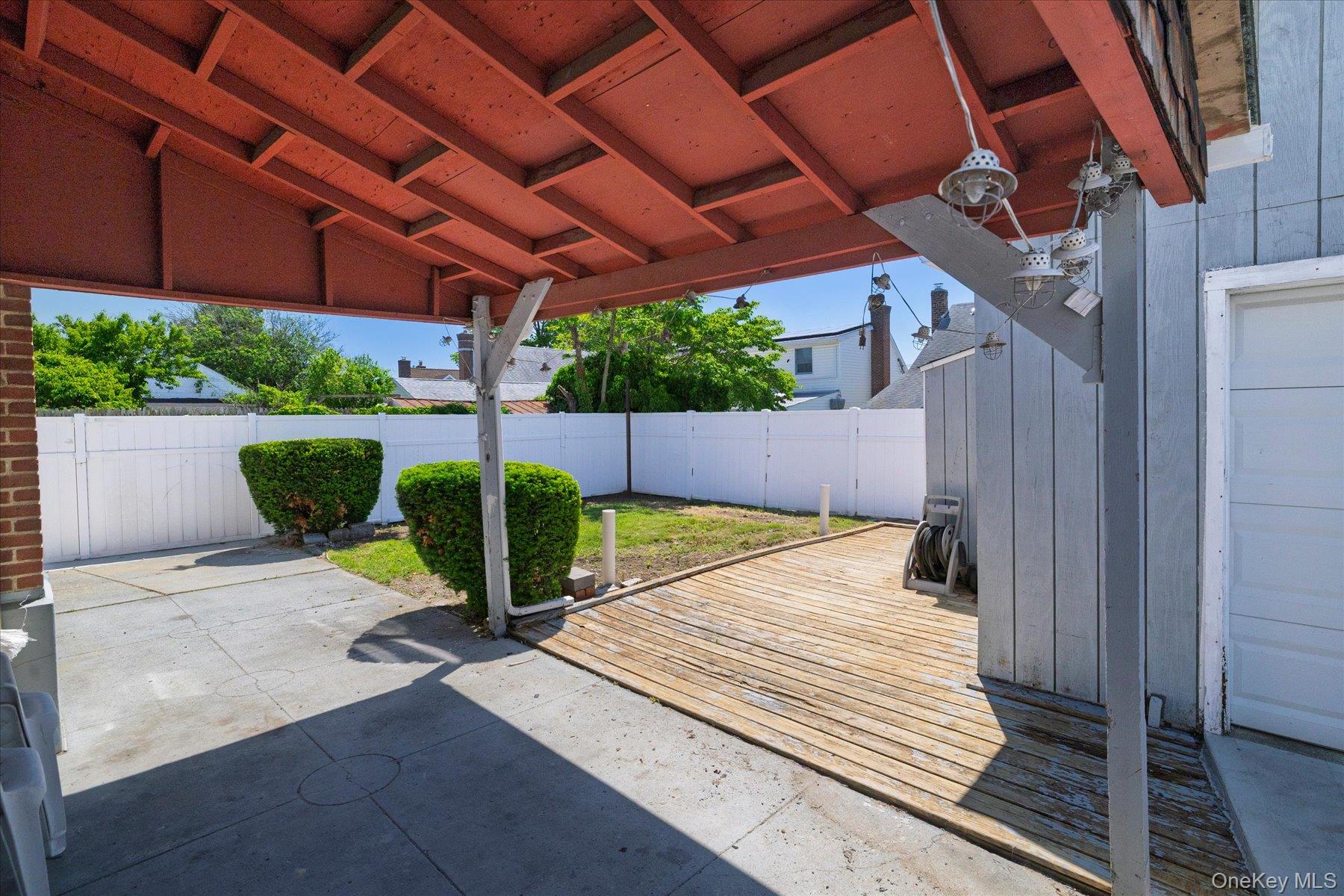 191 Raff Avenue Mineola, NY 11501 - Photo 6 of 25 a view of a patio with table and chairs with wooden floor