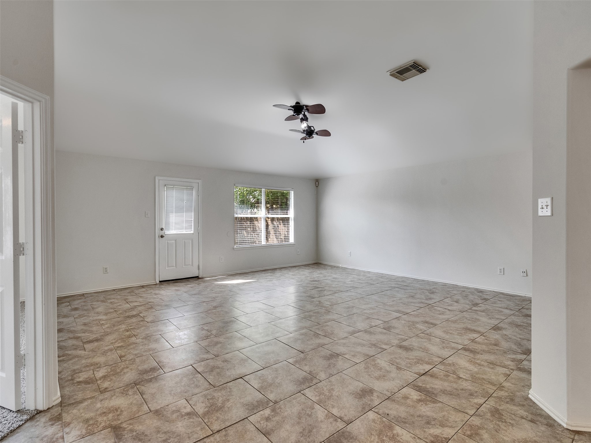 13431 Rural Oak Street Houston, TX 77034 - Photo 11 of 24 an empty room with windows and chandelier fan