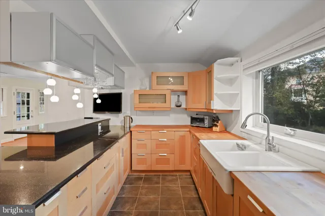 a large kitchen with stainless steel appliances granite countertop a sink and a stove
