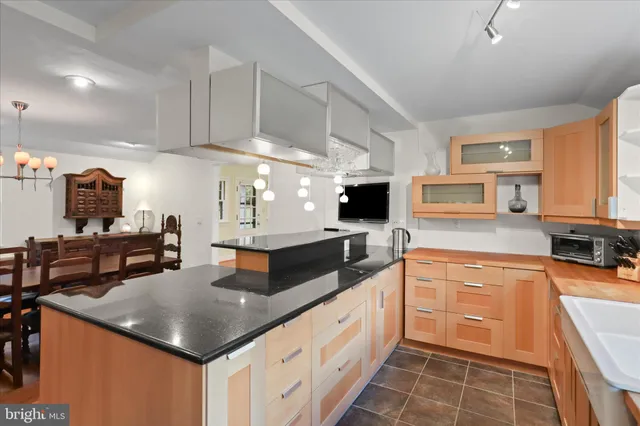 a kitchen with stainless steel appliances granite countertop a sink and a stove