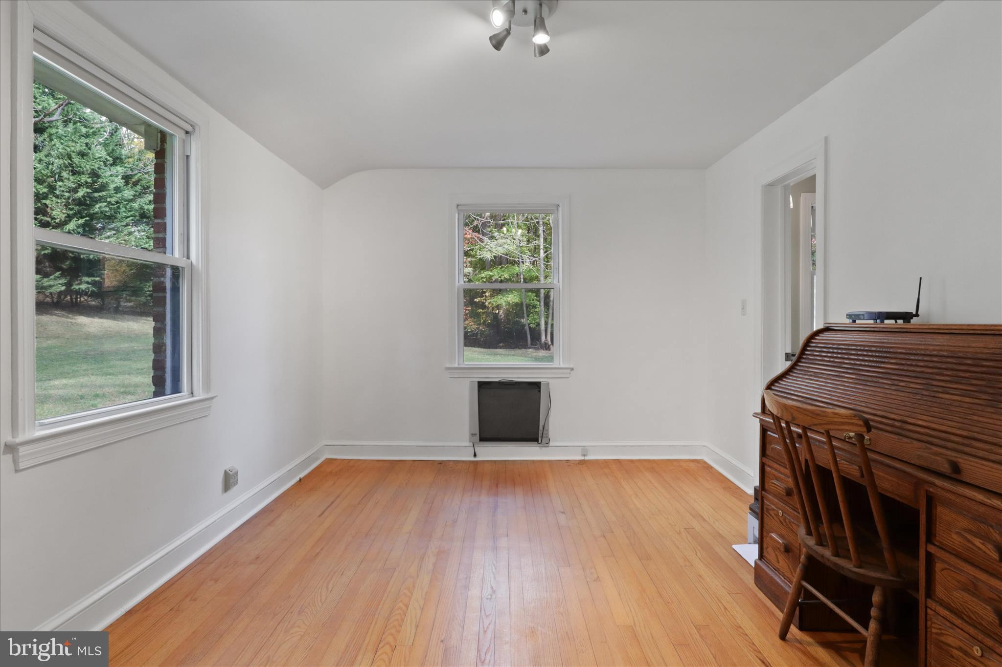 7914 Idylwood Road Dunn Loring, VA 22027 - Photo 15 of 41 an empty room with wooden floor cabinet and windows