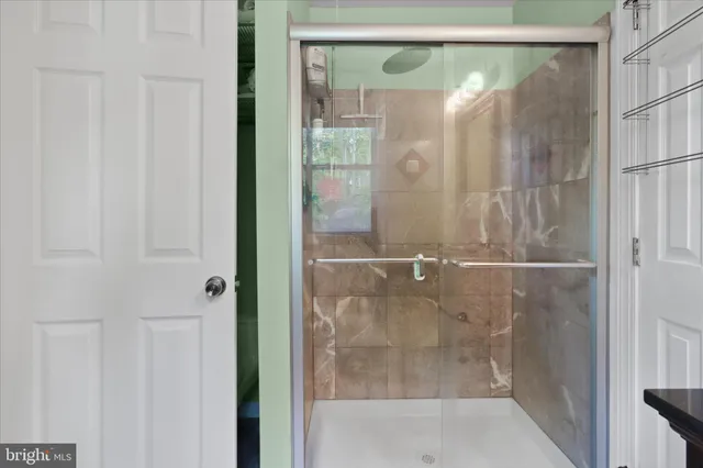 a bathroom with a glass shower door
